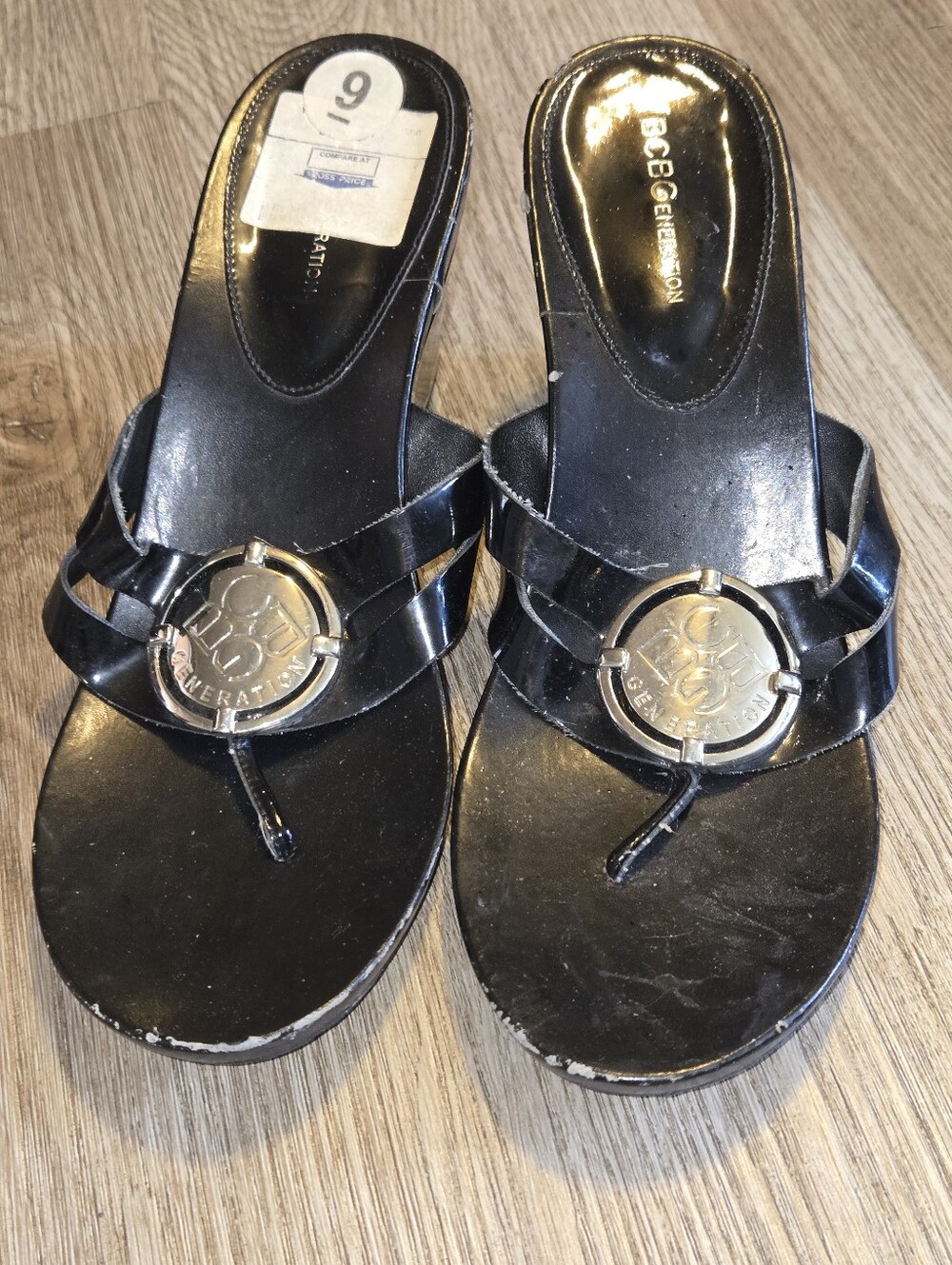 BCBGeneration Black Patent Thong Sandals with Gold Logo Accent